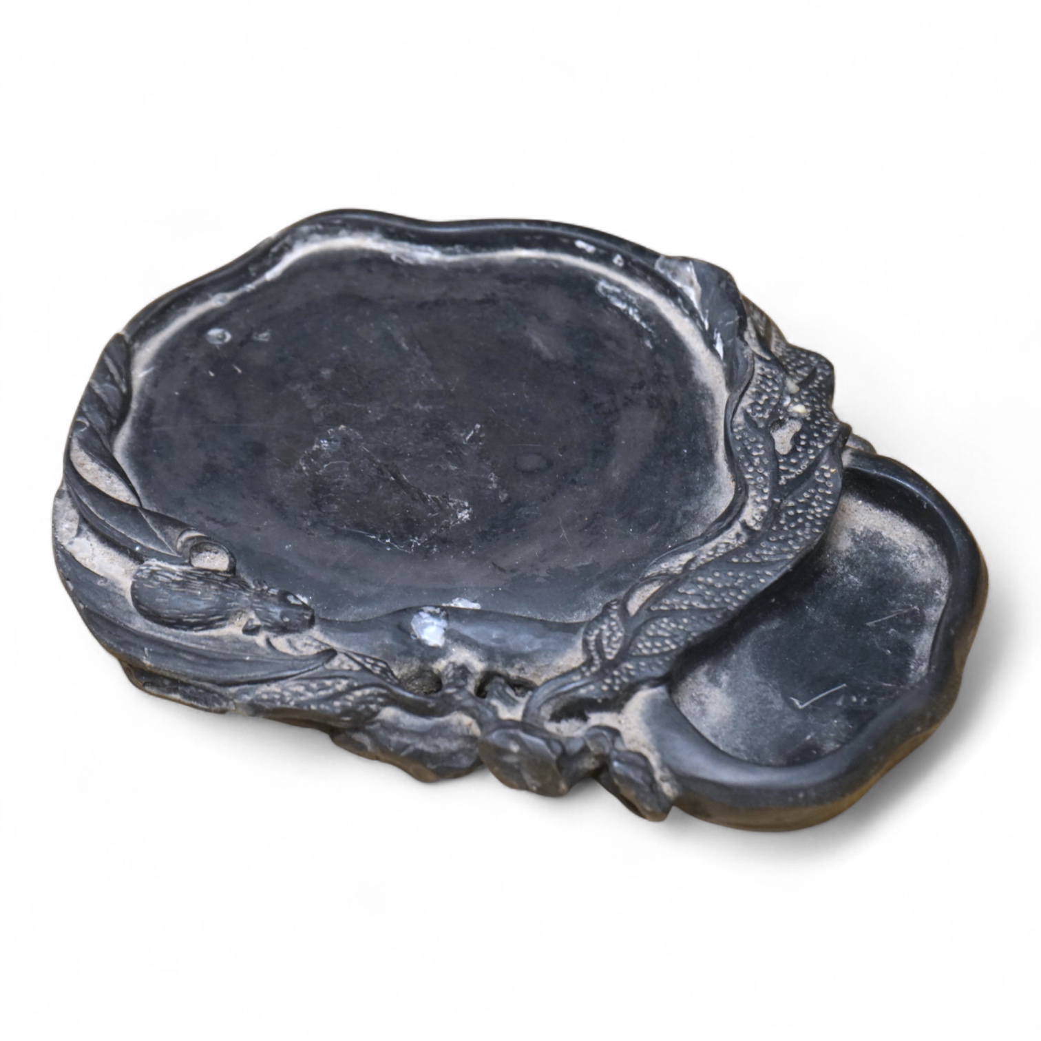 A Chinese carved inkstone, character marks to the base, 23cm